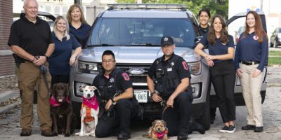REACH team in 2021: from left Lt. Tim Hetrick with therapy K9 Winston, Crisis Responder Amanda Brockway, Crisis Responder Becky Rowe, Officer Alex Tran with therapy K9 Lollipop, Officer Michael Mitrou with therapy K9 Rosie, Officer Elma Halpin, Crisis Outreach Coordinator Megan Cambron and Behavioral Health Detective Beth Visel REACH team in 2021: from left Lt. Tim Hetrick with therapy K9 Winston, Crisis Responder Amanda Brockway, Crisis Responder Becky Rowe, Officer Alex Tran with therapy K9 Lollipop, Officer Michael Mitrou with therapy K9 Rosie, Officer Elma Halpin, Crisis Outreach Coordinator Megan Cambron and Behavioral Health Detective Beth Visel